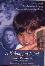 A boy with his head on top of a book.
