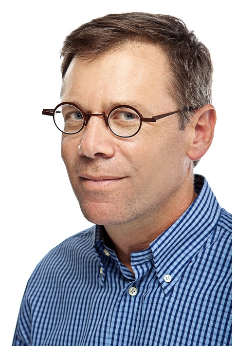 A man with glasses and a blue shirt