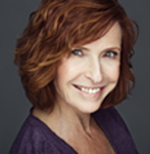A woman with red hair and a purple shirt