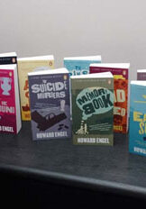 engel_cooperman_display_larger (1) A table topped with lots of books on top of it.